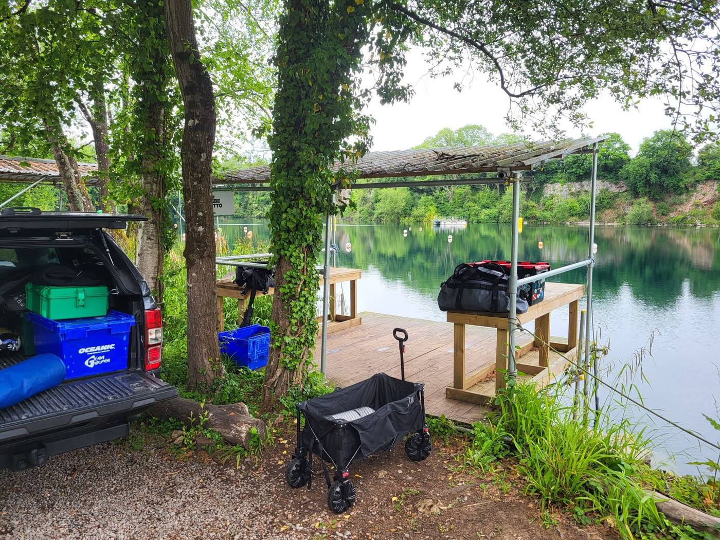 Kit unloaded from a pickup beside a covered lakeside platform